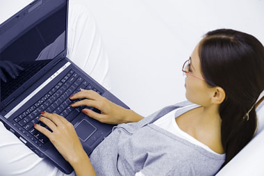 Woman Sat with Laptop Having online counselling
