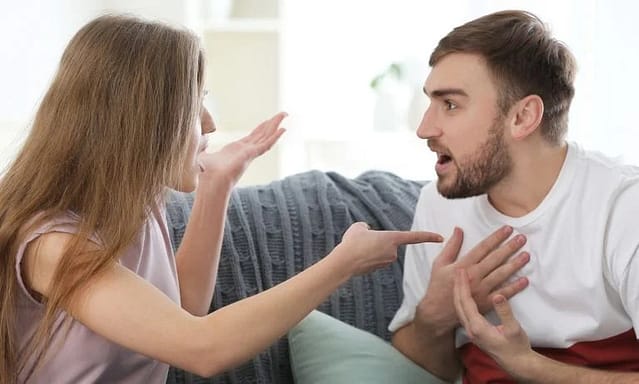 A woman pointing out his boyfriend that he is guilty in their relationship