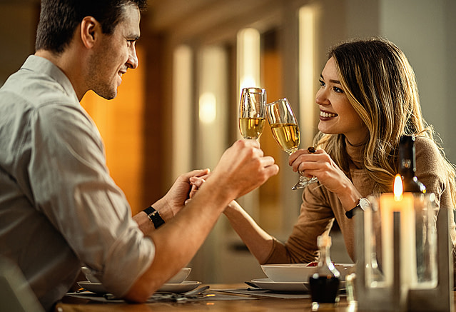 Couple enjoying their dating with a glass of Champagne