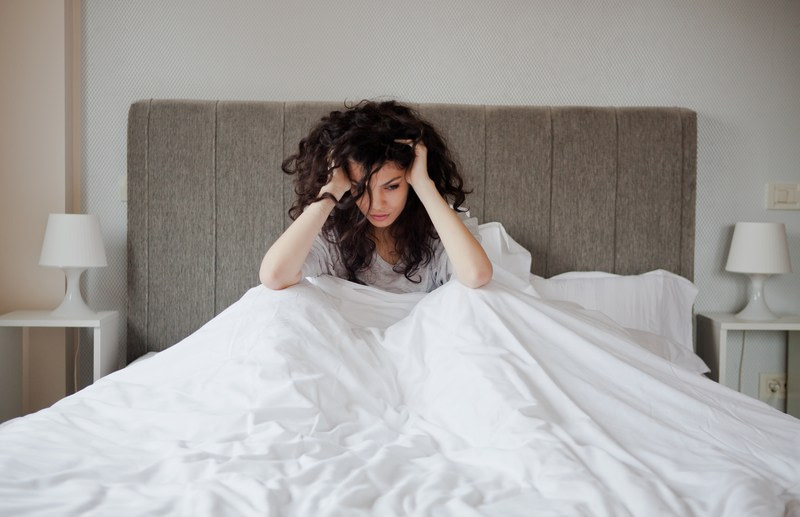 Woman is stress in bed and having some mental health issues